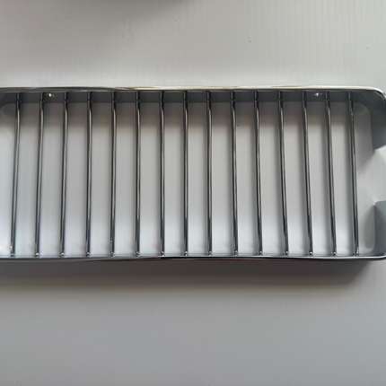 Metallic grill on a gray background